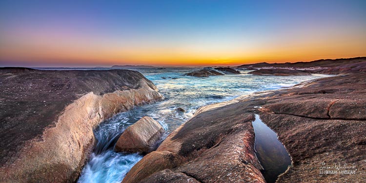 Water rushes between massive rocks under the sunset glow. Near Elephant Rocks, William Bay, Western Australia - landscape photographer